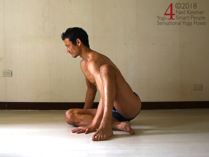 Astavakrasana preparation exercise, sitting with one arm resting against the back of one arm. Neil Keleher. Sensational Yoga Poses.