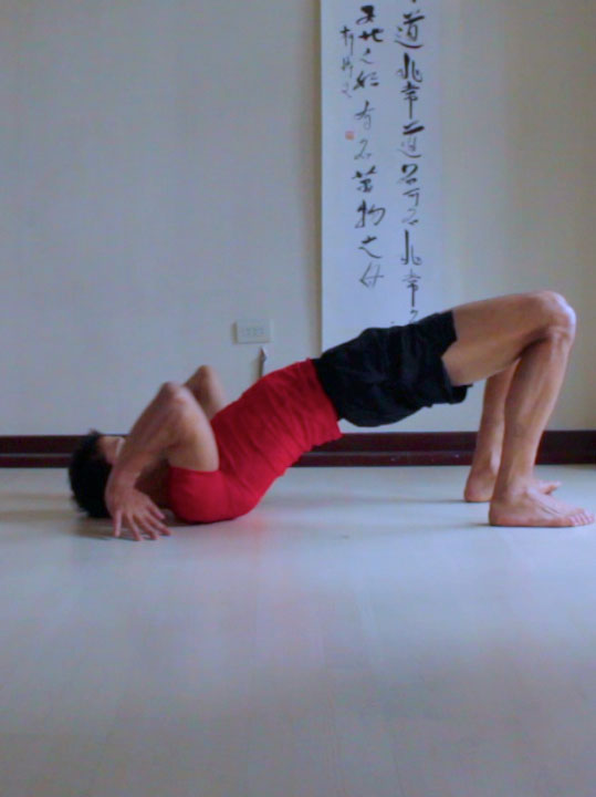 wheel pose, chakrasana or urdhva dhanurasana, lifting shoulders off of floor